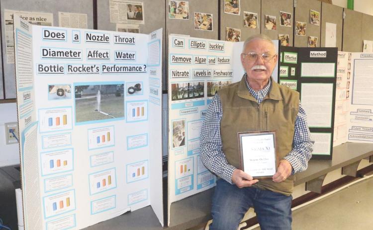Fort White Middle School science teacher Wayne Oelfke holds his plaque after being named the University of Florida Chapter Sigma Xi Teacher of the Year Award winner (TONY BRITT/Lake City Reporter)