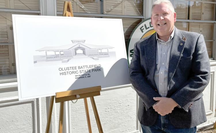 Rep. Chuck Brannan is pictured next to a rendering of the new Olustee Battlefield Historic State Park museum during the groundbreaking ceremony Friday at the park. (COURTESY)