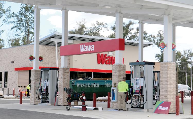 Signage was erected Tuesday on the Wawa convenience store at the U.S. Highway 90 and Ridgewood Avenue intersection. The store is expected to open in April. (TONY BRITT/Lake City Reporter)