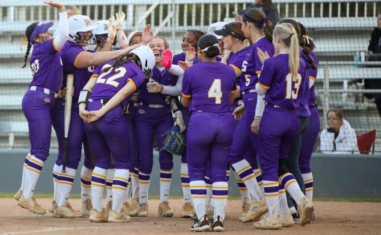 Columbia catcher Emily Delgado (22) is greeted at home plate by her teammates after hitting a two-run home run against Bartram Trail on Thursday. (BRENT KUYKENDALL/Lake City Reporter)
