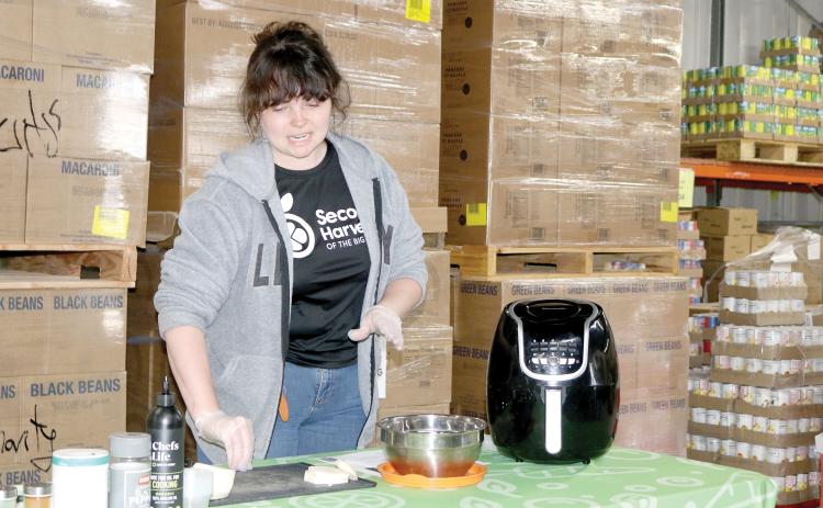Merrick Mitchell, a nutrition educator, prepares turnips during a food demonstration at Catholic Charities on Wednesday, kicking off its annual March against Hunger campaign. (TONY BRITT/Lake City Reporter)