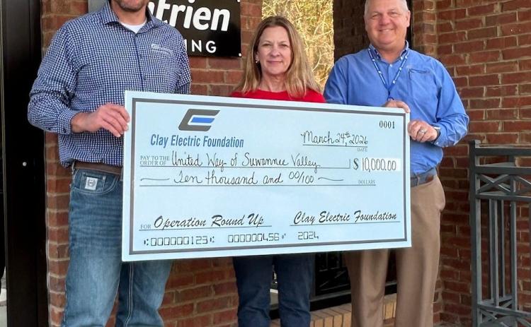 United Way of Suwannee Valley Executive Director Jennifer Anchors receives the $10,000 contribution from the Clay Electric Foundation from Jordan Wade, member relations representative (left), and District Manager Troy Adams. (COURTESY)