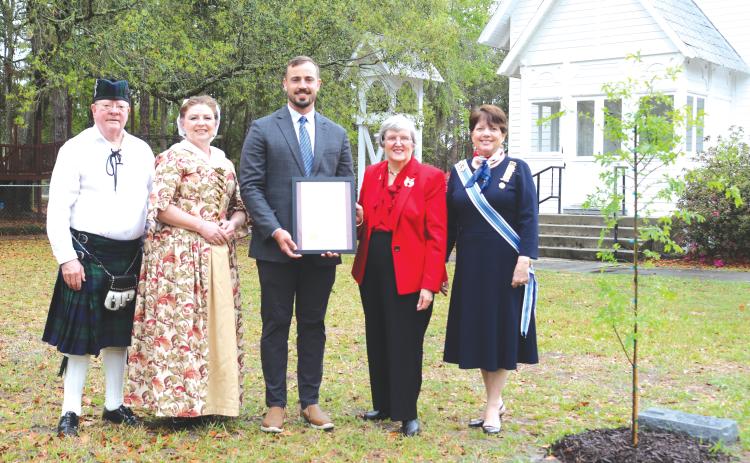David Chandler (from left), Sons of the American Revolution, Scarlet Frisina, Lake City Mayor Noah Walker, Jane McClelland, Daughters of the American Revolution, and Kay Yarbrough, Honorary State Regent of the Florida State Society Daughters of the American Revolution, pose next to the new Liberty Tree planted at St. James Episcopal Church in honor America’s 250th Anniversary on Wednesday for the Edward Rutledge Chapter, Daughters of the American Revolution. (TONY BRITT/Lake City Reporter)