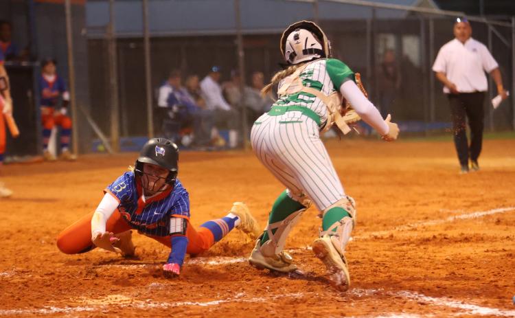 Branford right fielder Aurelia Darling slides safely into home plate past Suwannee catcher Addison Peterson on Thursday. (PAUL BUCHANAN/Lake City Reporter)
