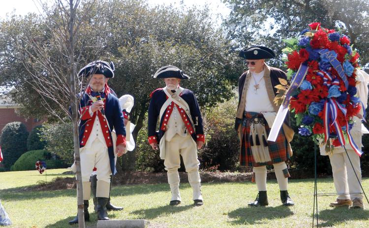 Chris Washler, the president of the Florida State Society of the Sons of the American Revolution, stands with other SAR members behind the liberty tree that was dedicated Saturday at Heritage Park and Gardens in Live Oak. (JAMIE WACHTER/Lake City Reporter)