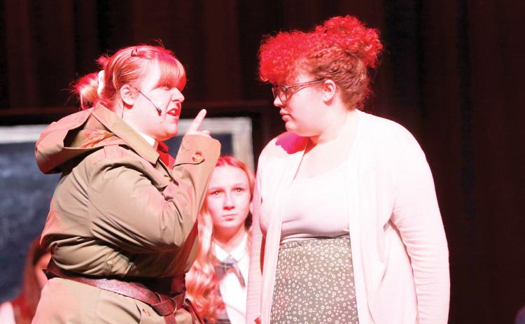 Miss Trunchbull, the headmistress at the school in ‘Matilda’ played by Lillian Sasser (left) scolds Matilda’s teacher Miss Honey, played by Jamylai Leon, during a scene from the Suwannee High theater troupe’s rehearsal for this weekend’s performances. (JAMIE WACHTER/Lake City Reporter)