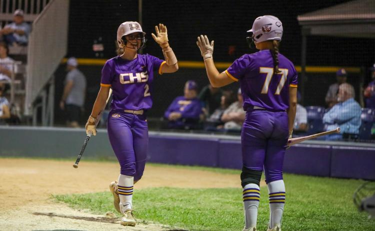 Columbia shortstop Alannah Lord (left) high fives Ryleigh Stone after scoring a run against Buchholz on Tuesday. (BRENT KUYKENDALL/Lake City Reporter)
