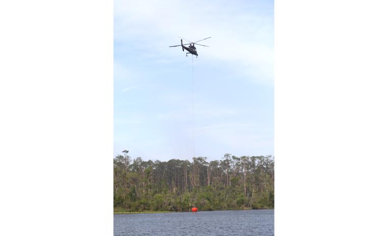Firefighting crews have been battling the Gun Range Fire in the Osceola National Forest since Sunday. That includes aerial support from planes and helicopters. (TONY BRITT/Lake City Reporter)