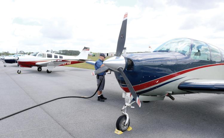 Casey Roach, a lineman at the Lake City Gateway Airport, fuels a Bonanza on Friday afternoon. At least 30 of the Beechcraft airplanes are at the airport practicing for a Wisconsin air show. (TONY BRITT/Lake City Reporter)