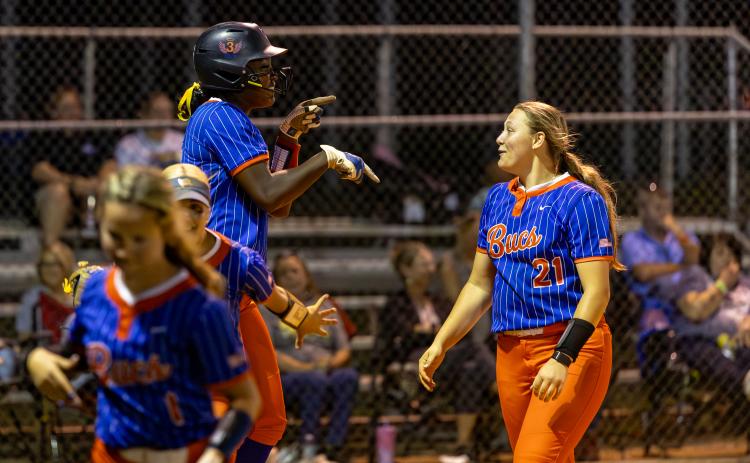 Branford first baseman Mallory Blue (left) celebrates with pitcher Harleigh Price after hitting a three-run home run against Fort White in the District 6-R semifinals on Tuesday. (JACK HOWDESHELL/Lake City Reporter)