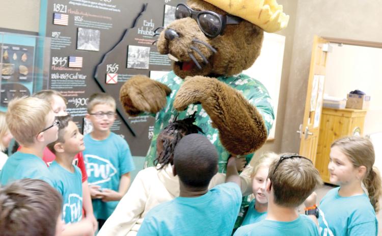 Local elementary school students meet Bellamy Beaver during a water conservation and quality event at Ichetucknee Springs State Park on Thursday morning. (TONY BRITT/Lake City Reporter)