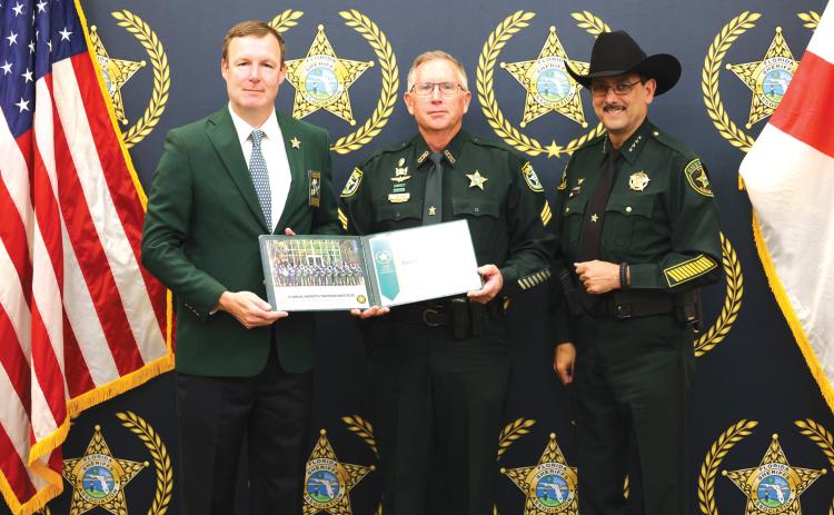 Columbia County Sheriff’s Office Sergeant Sean Sikes (center) receives his certificate after graduating from the Florida Sheriffs Association Commanders Academy from FSA Executive Director Matt Dunagan (left) and Marion County Sheriff Billy Woods, the FSA vice president. (COURTESY)