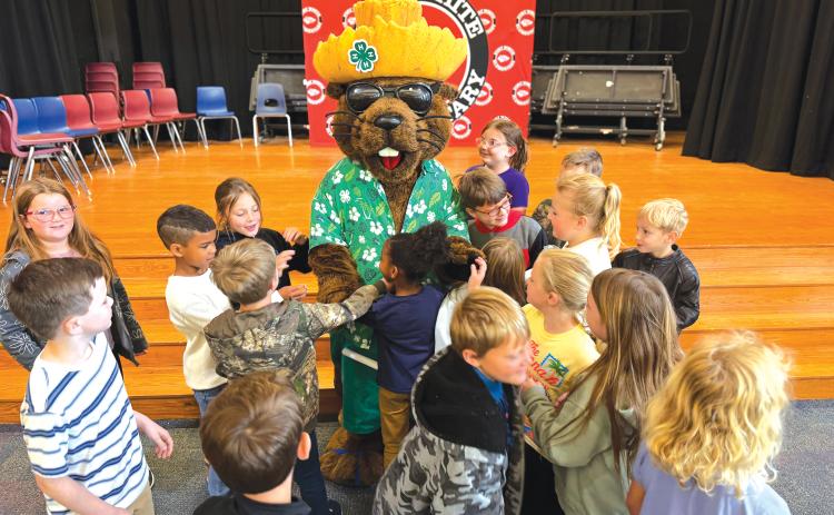 Fort White Elementary School second graders crowd Bellamy Beaver at the end of his visit to the school. (COURTESY)
