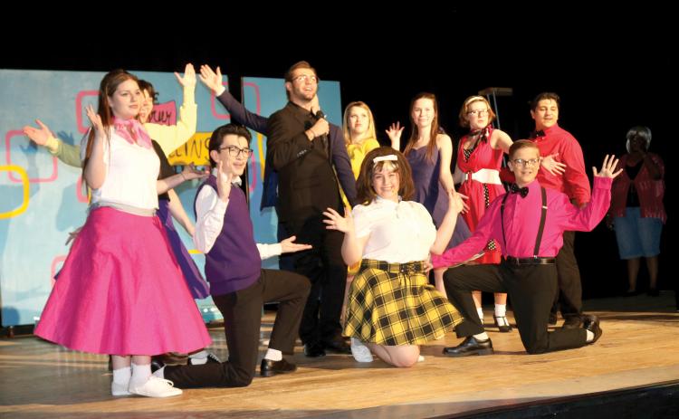 Columbia High School students performing in the school’s production of ‘Hairspray the Musical’ pause after completing a song. (TONY BRITT/Lake City Reporter)