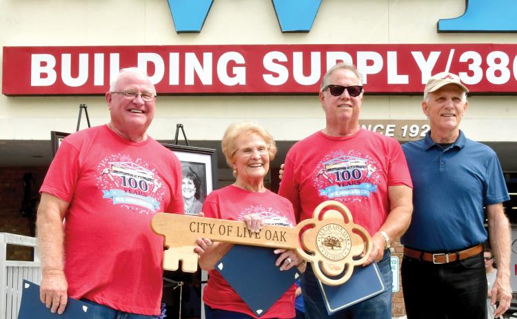 Live Oak Mayor Frank Davis (right) presented a key to the city to W.B. Howland Company owner Lyn Fletcher (second from right), Barbara Howland and Bill Howland during the company’s 100-year celebration Saturday. (ROB WOLFE/Lake City Reporter)