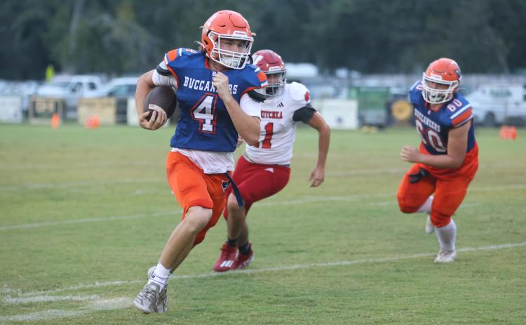Branford quarterback Trent Land breaks into the open field against Wewahitchka last season. (FILE)