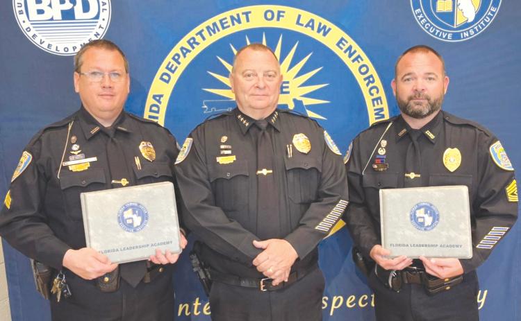 Lake City Police Sergeant Mike Lee (left) and First Sergeant Kevin Johns (right) stand with LCPD Chief Gerald Butler after earning their certificates at the Florida Leadership Academy. (COURTESY)