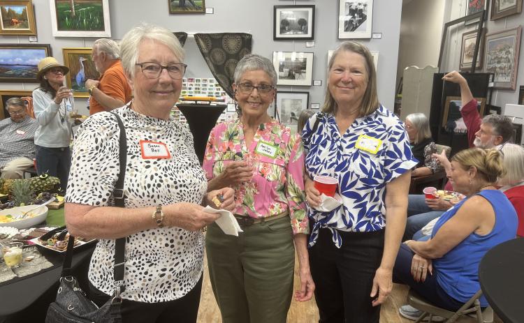 Susan Bell, secretary of the Live Oak Artists Guild (from left), Marilyn Jones, president, and Chris Flanagan, vice president, gather with attendees during the opening reception for the Guild’s exhibition at the Gateway Art Gallery in Lake City. (COURTESY)