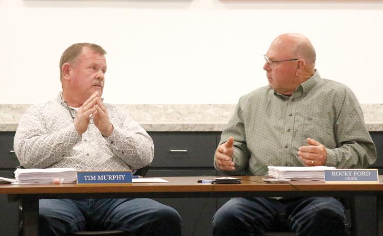 Columbia County Commissioners and North Florida Water Utilities Authority members Tim Murphy and Rocky Ford argue on the county’s sale of the sewer plant at the North Florida Mega Industrial Park to the City of Lake City during the board’s Monday meeting. (JAMIE WACHTER/Lake City Reporter)
