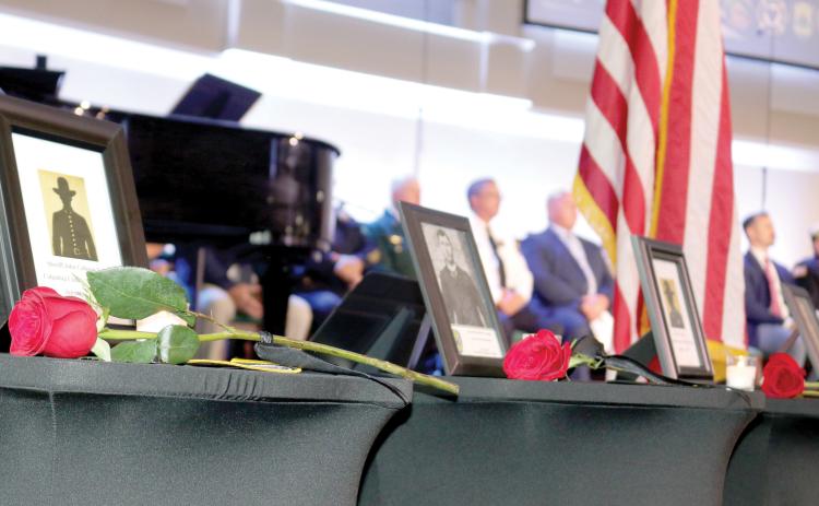 Roses, which were laid in honor of Columbia County first responders who lost their lives in the line of duty, rest on tables featuring the fallen first responder’s photo and patch representing the agency he worked for. The memorial service took place at Parkview Baptist Church on Tuesday afternoon. (TONY BRITT/Lake City Reporter)