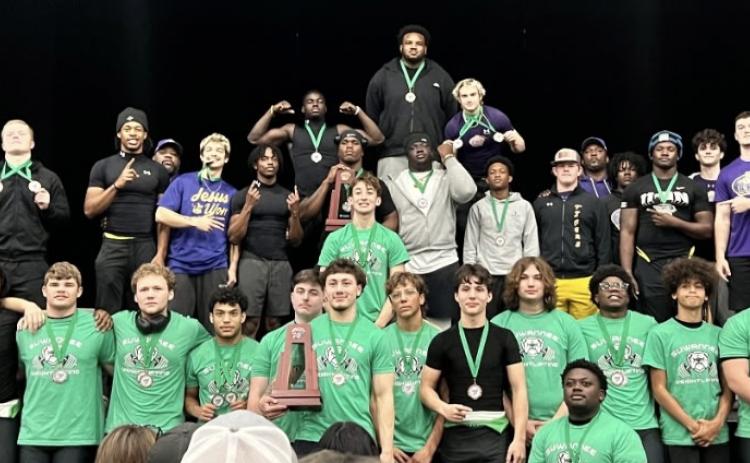 District 3-2A traditional champion Columbia and runner-up Suwannee show off their trophies and medals on Saturday. (COURTESY)