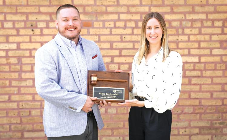 Outgoing United Way of Suwannee Valley President Blake Kuykendall (left) is awarded a ceremonial gavel by President-Elect Lindsey Covington. (COURTESY)