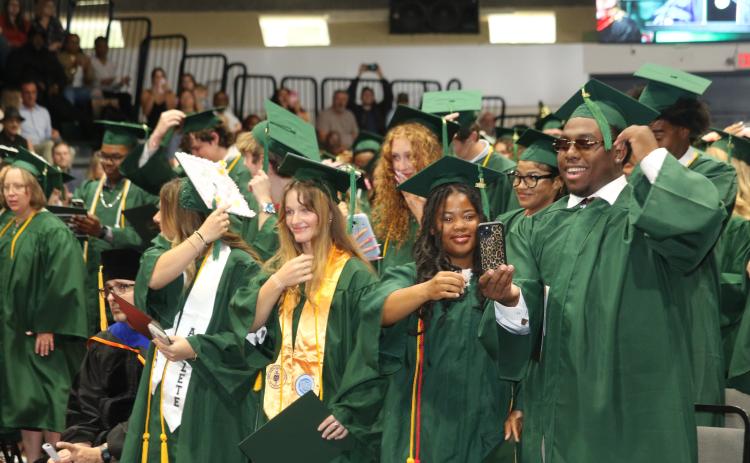 Florida Gateway College students turn their tassels after graduating on Friday morning. (TONY BRITT/Lake City Reporter)