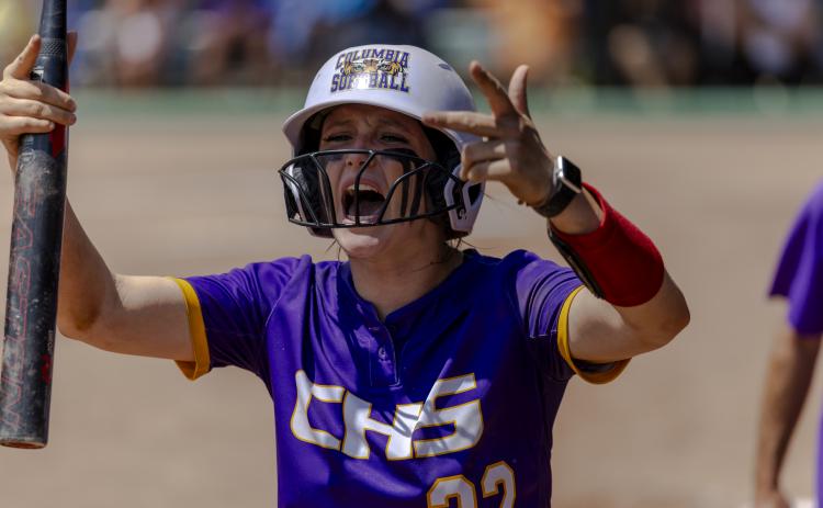 Columbia catcher Emily Delgado encourages the CHS student section to get up for her team after scoring a run following her RBI double in the seventh inning of Thursday's Class 4A state semifinal against Seminole. (JACK HOWDESHELL/Lake City Reporter)