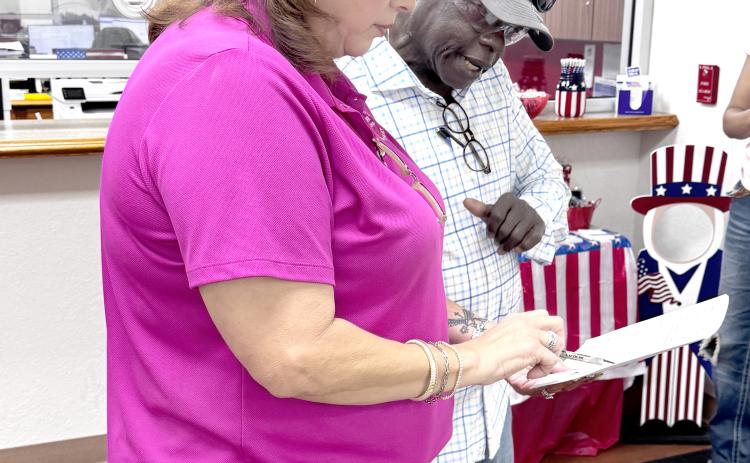 Suwannee County Supervisor of Elections Jennifer Kinsey shows Live Oak City Councilman Tommie Jefferson the vote totals from Tuesday’s city election. Jefferson advanced to a runoff election for the District 1 seat. (JAMIE WACHTER/Lake City Reporter)