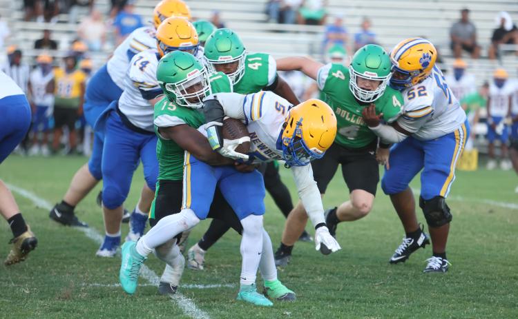 Photos by PAUL BUCHANAN/Lake City Reporter Suwannee linebacker Marcos Rojas tries to bring down Newberry running back Jamarcus Wimberly during Friday’s spring game.