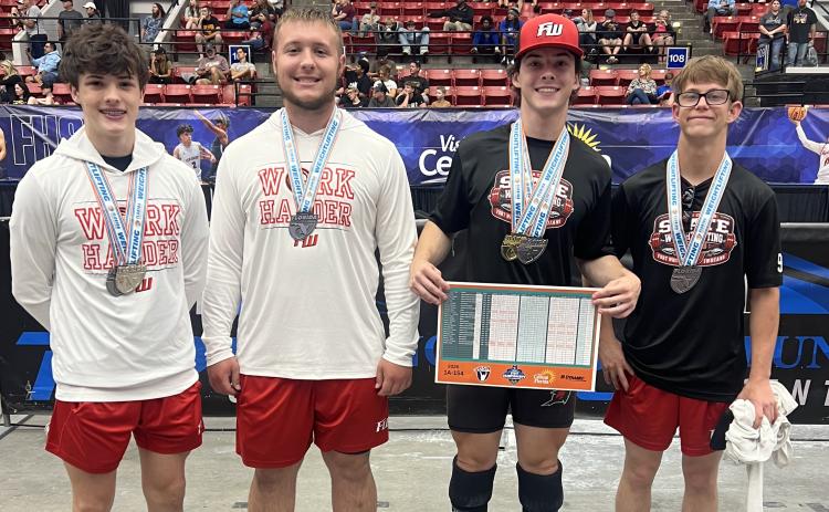 Fort White lifters Andrew Ulsch (from left, second in Olympic and fifth in traditional), Adam Ford (fifth in Olympic), Jonathan Ulsch (state champion in traditional, second in Olympic) and Matthew Koontz (fourth in traditional) all reached the medal stand at the Class 1A state meet on Friday. (COURTESY)