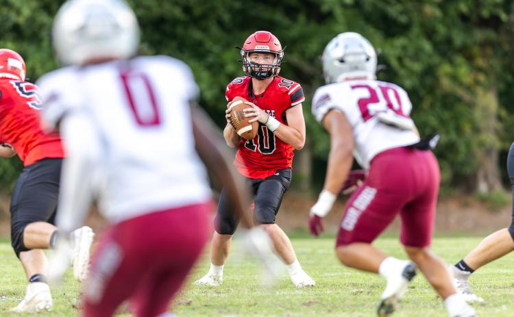 Lafayette quarterback Tucker Higginbotham drops back to pass against Madison County during the teams' spring game on Tuesday. (JACK HOWDESHELL/Lake City Reporter)