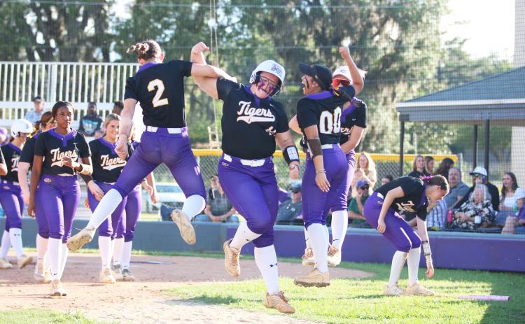 Columbia third baseman Josie Raulerson celebrates with teammates after hitting a solo home run against Arnold in the Region 1-4A semifinals on Wednesday. (JORDAN KROEGER/Lake City Reporter)