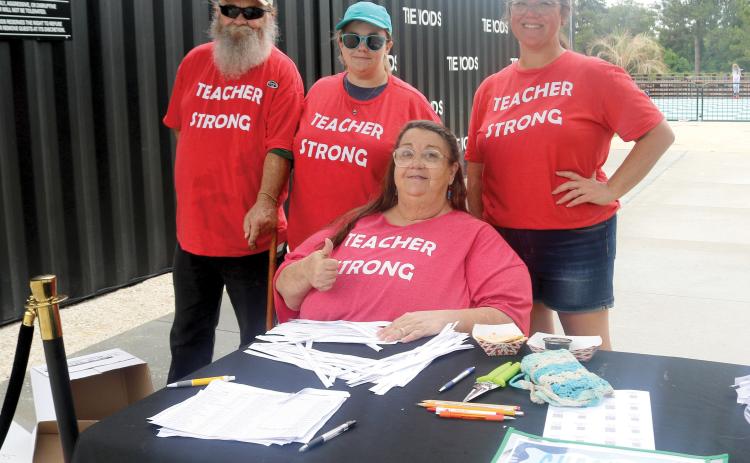 James Delaney (from left), Julia Jones, Jenee Delaney, president of the Columbia Teachers Association, and Kristen Smith, Columbia Teachers Association Executive Board member, pose for a picture while welcoming local educators to the 2026 Teacher Fête on Saturday at The Woods. (TONY BRITT/Lake City Reporter)