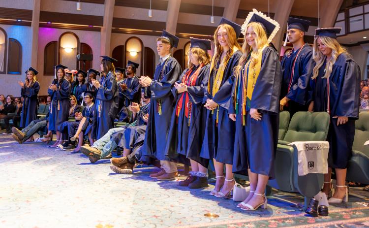 Belmont Academy valedictorian Chelsie Johnson (right) and salutatorian Jenavieve Farer stand with fellow graduates during Saturday’s commencement ceremony. (RAY CARPENTER/Lake City Reporter)