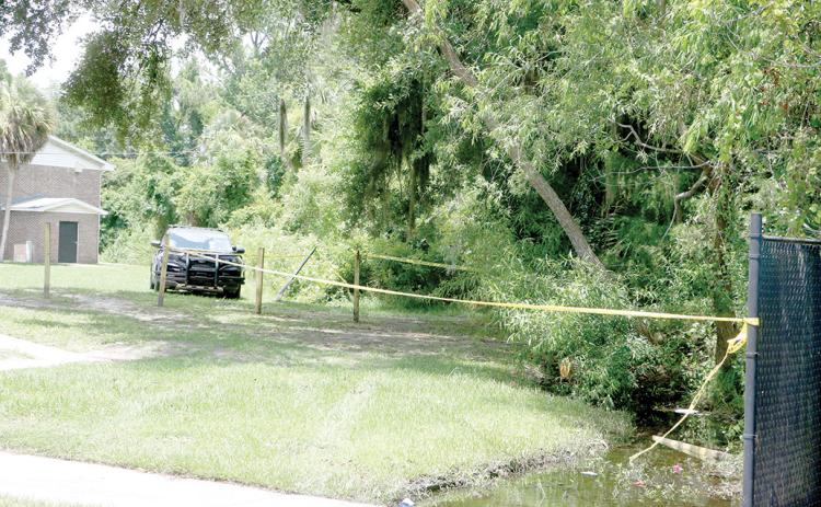 An area outside an apartment building is blocked off Tuesday afternoon following a fatal late-morning shooting outside an apartment building on NW Albright Place on the north side of Lake City. (MORGAN MCMULLEN/Lake City Reporter)