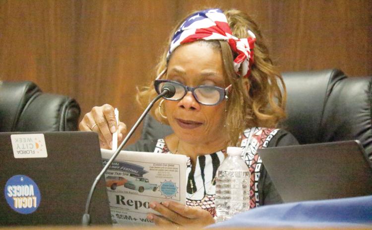 Live Oak Councilwoman Vanessa Brown Robinson looks at last week’s Live Oak Reporter to reference the impact the city budget would experience from the proposed property tax cuts during Tuesday’s council meeting. (JAMIE WACHTER/Lake City Reporter)