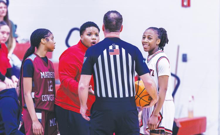 Fort White coach Bregay Harris questions a call to a referee while guard Javiona Roberson (right) smiles during the Region 3-R semifinals against Madison County on Feb. 13. (FILE)