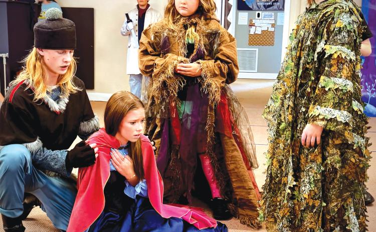 Abram Webb (from left) as Kristoff, Ainzli Kenney as Anna, Chatlynn Childs as Bulda, and Emery Webb as Pabbie rehearse a scene for the upcoming Practically Perfect Performing Arts production of ‘Frozen Jr.’ (COURTESY)