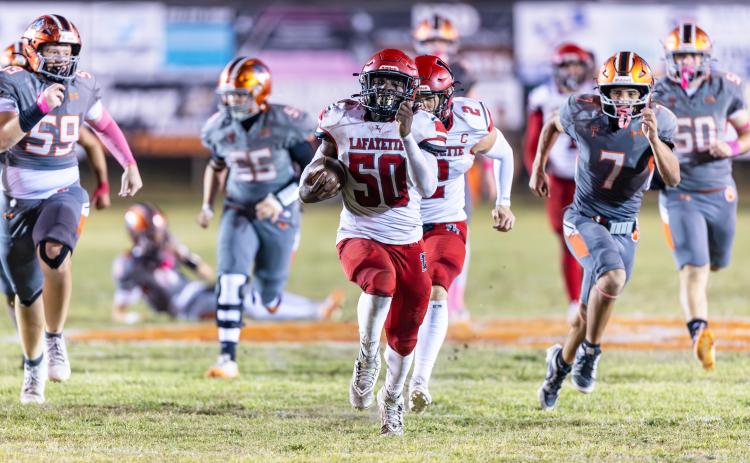 Lafayette defensive lineman Zamarion Hawkins returns a fumble for a touchdown against Trenton last season. The two teams will meet this fall on Oct. 16 in Mayo. (FILE)