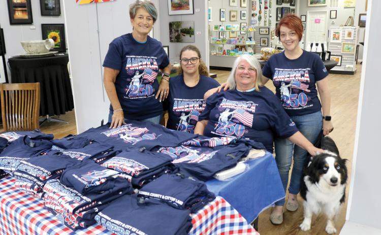 Lisa Amparo (from left), Mikael Byrd, Kathy Olson, Shelia Carr and Cooper take pose for a photo with the 250th anniversary celebration T-shirts while at the Gateway Art Gallery on Tuesday afternoon. The T-shirts are for sale at $10 each. (TONY BRITT/Lake City Reporter)