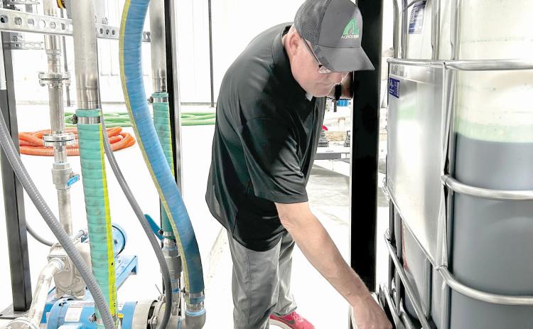 AgroLiquid site manager Jeff Herald prepares ingredients inside the Lake City facility. (COURTESY AGROLIQUID)
