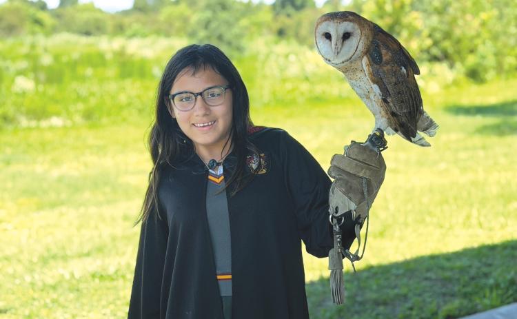 Lily Weaver gets the opportunity to hold an owl during the Columbia County 4-H Year Two session of the School of Life Skills for Magical Beings camp from June 22-26. (COURTESY COLUMBIA COUNTY 4-H)