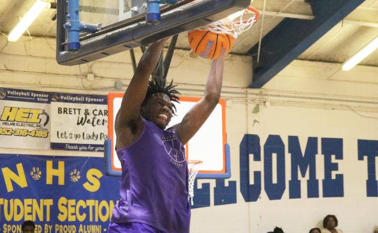 Columbia center Ty’avious Cooper dunks against Newberry during the Tigers’ summer league finale on Tuesday. (JORDAN KROEGER/Lake City Reporter)