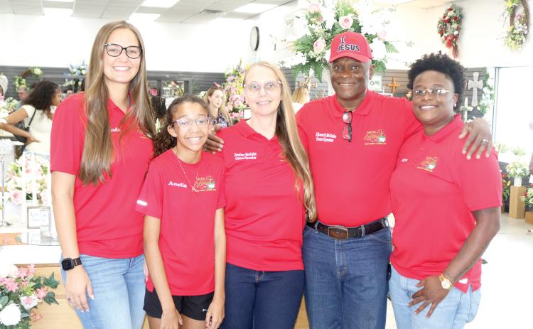 Lake City Florist family and owner/operators pose for a picture during the store’s grand re-opening on Thursday afternoon. Amanda Ivey (from left), Amelia Scott, Heather LeAnne McGuire, Ellsworth James McGuire Sr. and Briya McGuire. (TONY BRITT/Lake City Reporter)