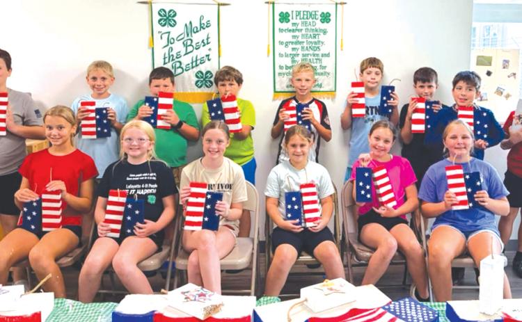 Lafayette County 4-H Camp USA campers display their patriotic crafts. Campers were able to learn about the rights, responsibilities and opportunities that come with being an American citizen. (COURTESY LAFAYETTE COUNTY 4-H)