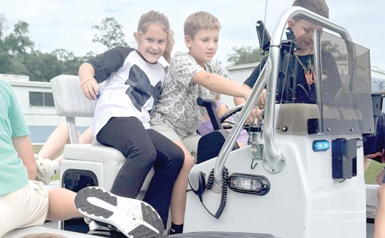 Campers checking out the Florida Wildlife Commission boat while learning about boating safety. (COURTESY LAFAYETTE COUNTY 4-H)