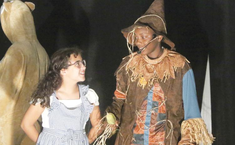 Aaliyah Salva (left) and Khloe Maddox meet for the first time as Dorothy and the Scarecrow during rehearsal for New Generation Christian School’s upcoming production of ’The Wizard of Oz.’ The play is set to be performed Friday at 6:30 p.m. on the school’s campus. (MORGAN MCMULLEN/Lake City Reporter)