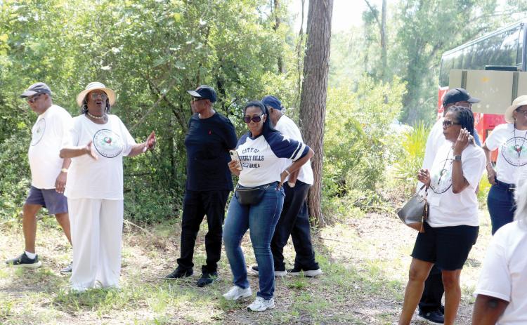 Leila Williams (far left) talks about the Union Burial Ground Cemetery where Hankerson family members were buried. Williams helped organize the tour for Hankerson family descendants through Columbia, Hamilton and Suwannee counties last Saturday. (TONY BRITT/Lake City Reporter)