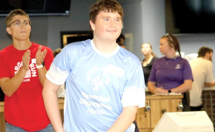 A Special Olympics Florida athlete from Columbia County looks down the lane as he releases a bowling ball during the Columbia County Special Olympics Bowling competition on Friday morning at Lake City Bowl. (TONY BRITT/Lake City Reporter)